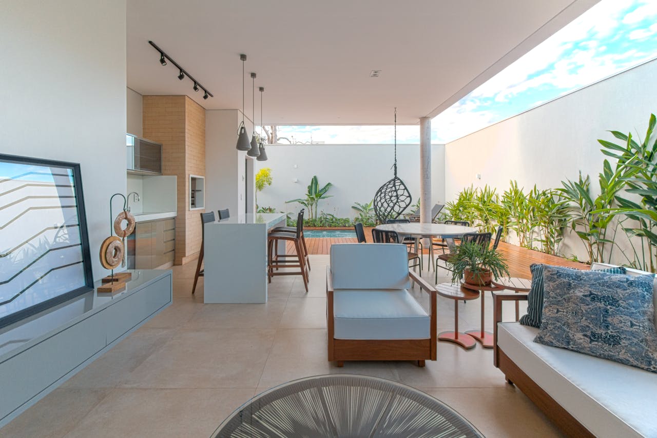 Stylish open-air veranda with chic furniture and lush plants.